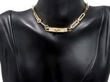 a close up of a mannequin torso wearing a gold chain necklace