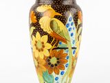 a vase with a bird and flowers painted on it