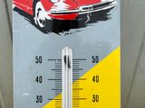 a thermometer with a picture of a red car on it
