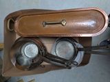 two pots and pans in a box on the floor
