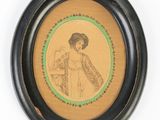 an old picture of a woman in a dress is shown in a black frame