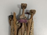 a piece of drift wood with a hammer and a piece of wood