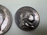 a silver coin with a picture of a man on it