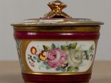 a close up of a bowl with a lid on a table
