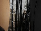 many different types of surfboards and paddles in the room