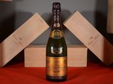 a bottle of champagne sitting on a red table cloth