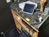 a small desk with a tablet on top of it