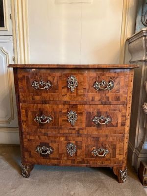 a wooden chest of drawers with many drawers on it