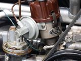 a close up view of a car ' s engine with a red cap on it