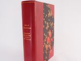 a red book that is sitting on a white surface