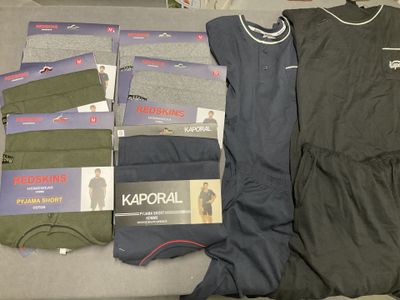several pairs of men ' s underwear are laid out on a bed