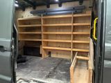 the back of a van with shelves in the back of it