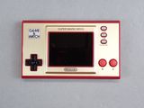 a red and white game and watch sitting on a table