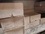 many boxes on a shelf in a room