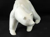 a white bear figurine on a black background