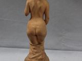 an image of a statue of a woman standing on a pedestal
