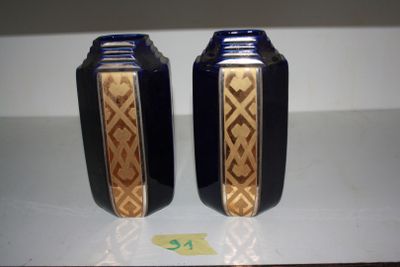 two blue vases sitting on a white table