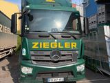 un camion vert garé à côté d'un autre camion
