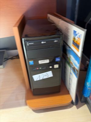 a desktop computer sitting on top of a wooden desk