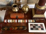 a small table with pictures and a vase on it