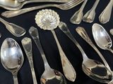 a lot of silver spoons and spoon spoons on a table