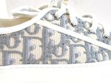 a close up of a pair of sneakers with a monogram pattern