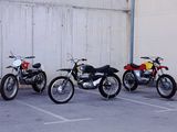 three motorcycles parked in a row in a parking lot