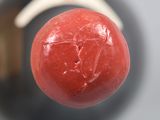 a close up view of a red ball with a white handle
