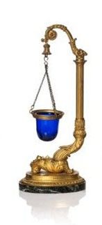 a gold and blue scale with a chain hanging from it