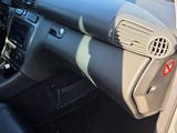 a car dashboard with a black leather seat and a black dash mat