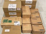 boxes of panasonic products stacked on top of each other on the floor