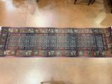 a rug on the floor in a room with chairs and a table