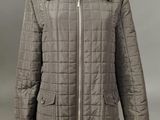 a woman ' s jacket with a zippered collar and a zippered collar