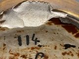 a close up of a brown vase with writing on it