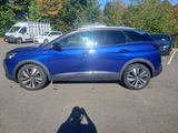 the blue car is parked in a parking lot with other cars in the background