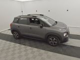 the small suv is parked in the garage on the checkered floor