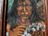 painting of a native american woman holding a kitten in her hands