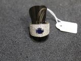 an image of a ring with a blue sapphire and diamonds on it