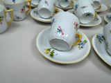 a lot of cups and saucers on the table