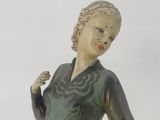 a statue of a woman holding a frisbee in her hand