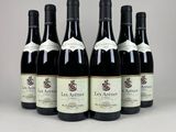 six bottles of wine are lined up in a row