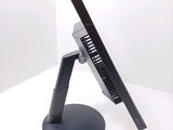 a laptop computer sitting on a stand on a white surface