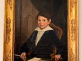 a painting of a young boy sitting at a desk