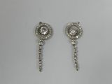 a pair of earrings with diamonds on a white background