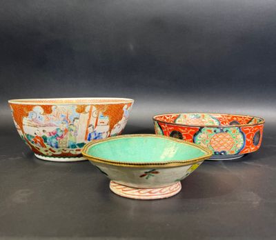 three different colored bowls sitting on top of a black surface