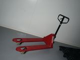 a red hand truck that is sitting on the floor