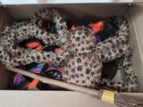 a cardboard box filled with assorted items and a broom