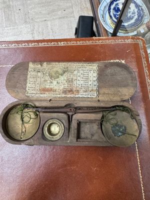 a small box with a clock inside of it on a table