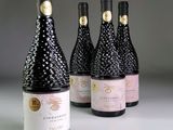 trois bouteilles de vin sont alignées sur une table