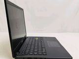 the back of a laptop computer sitting on top of a white table